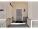 Close-up of the home's entryway featuring neutral columns and a secure screen door at 20626 N 55Th Ave, Glendale, AZ 85308