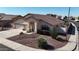 Charming single-Gathering home featuring a well-manicured lawn, a two-car garage, and desert landscaping at 20626 N 55Th Ave, Glendale, AZ 85308
