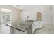 Bright kitchen island featuring granite countertops, stainless steel sink, and white cabinetry at 20626 N 55Th Ave, Glendale, AZ 85308