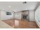 Bright living room with wood floors, a stone fireplace, and an entertainment center at 20626 N 55Th Ave, Glendale, AZ 85308