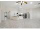 Spacious living room boasts tiled floors, recessed lighting, and white kitchen with stainless appliances at 20626 N 55Th Ave, Glendale, AZ 85308