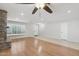 Open living room showcasing wood floors, stone fireplace, and ample natural light at 20626 N 55Th Ave, Glendale, AZ 85308