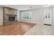 Inviting living room with a stone fireplace, wood floors, and plantation shutters at 20626 N 55Th Ave, Glendale, AZ 85308