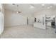 Open-concept living space with tile flooring, ceiling fan, and kitchen island with bar seating at 20626 N 55Th Ave, Glendale, AZ 85308
