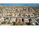 High-angle aerial capturing the neighborhood's layout, emphasizing the desert setting, landscaping and a distant pool at 27250 N 86Th Ave, Peoria, AZ 85383