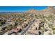 Expansive aerial view of a desert community, highlighting the neighborhood layout against a backdrop of majestic mountains at 27250 N 86Th Ave, Peoria, AZ 85383