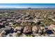 Panoramic aerial shot of homes in a neighborhood showcasing desert landscaping, terracotta roofs and mountain views at 27250 N 86Th Ave, Peoria, AZ 85383