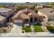 Stunning aerial view of a single-story home showcasing manicured landscaping, desert surroundings, and a tile roof at 27250 N 86Th Ave, Peoria, AZ 85383
