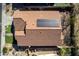 Rooftop shot displaying installed solar panels and backyard landscape, including a putting green, fire pit, and patio at 27250 N 86Th Ave, Peoria, AZ 85383