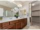 Bathroom vanity with double sinks, white countertops, and wood cabinets at 27250 N 86Th Ave, Peoria, AZ 85383