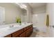 Spacious bathroom featuring a double sink vanity, a soaking tub, and travertine tile at 27250 N 86Th Ave, Peoria, AZ 85383