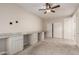 This bedroom has neutral walls, carpeted floors, a ceiling fan, and a built-in desk at 27250 N 86Th Ave, Peoria, AZ 85383