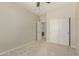The bedroom features carpeted floors, neutral walls, closet, and an open door leading to a bathroom at 27250 N 86Th Ave, Peoria, AZ 85383