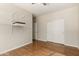 This bedroom features laminate flooring, built in shelving, and a closet at 27250 N 86Th Ave, Peoria, AZ 85383