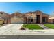 Charming single-story home featuring desert landscaping, a decorative tree, and a spacious driveway leading to the garage at 27250 N 86Th Ave, Peoria, AZ 85383