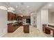 Gourmet kitchen with dark wood cabinets, a center island, and open layout to the living areas at 27250 N 86Th Ave, Peoria, AZ 85383