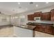 Stylish kitchen featuring dark wood cabinets, an island with seating, and stainless steel appliances at 27250 N 86Th Ave, Peoria, AZ 85383