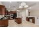 This is a spacious kitchen featuring dark wood cabinetry, granite countertops, and stainless steel appliances at 27250 N 86Th Ave, Peoria, AZ 85383