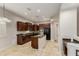 Updated kitchen with dark wood cabinets, granite counters, and convenient island workspace at 27250 N 86Th Ave, Peoria, AZ 85383