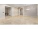 Open-concept living space featuring travertine floors, an arched doorway, and ample natural light at 27250 N 86Th Ave, Peoria, AZ 85383