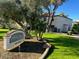 Beautifully landscaped exterior of property showcasing lush green grass, mature trees, and signage at 2938 N 61St Pl # 234, Scottsdale, AZ 85251