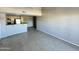 Bright and spacious living room with neutral tile flooring, a large window, and open access to the kitchen at 2938 N 61St Pl # 234, Scottsdale, AZ 85251