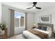 Bright bedroom featuring a ceiling fan, neutral decor, large window with curtains and stylish contemporary furnishings at 3551 N 12Th St # 104, Phoenix, AZ 85014