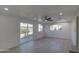 Open living room with recessed lighting, ceiling fan, light-colored floor and sliding glass doors to backyard at 3740 E Yale St, Phoenix, AZ 85008