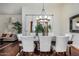 Dining room featuring a modern chandelier, seating for six, and access to living spaces at 4034 E Hope St, Mesa, AZ 85205