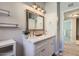 Bright bathroom featuring a double sink vanity with a large framed mirror at 4525 E Rhonda Dr, Phoenix, AZ 85018