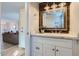 Charming powder room featuring a rustic wood-framed mirror, modern fixtures, and stylish vanity at 4525 E Rhonda Dr, Phoenix, AZ 85018
