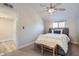 Cozy bedroom with a ceiling fan, accent bench, and neutral color palette at 4525 E Rhonda Dr, Phoenix, AZ 85018