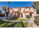 Charming stucco townhome with a red tile roof, manicured lawn, and inviting walkway at 4525 E Rhonda Dr, Phoenix, AZ 85018