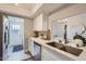 Modern kitchen with quartz countertops, stainless steel appliances, white cabinetry and a view to the dining area at 4525 E Rhonda Dr, Phoenix, AZ 85018
