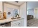 Modern kitchen with quartz countertops, stainless steel appliances, white cabinetry and a view to the dining area at 4525 E Rhonda Dr, Phoenix, AZ 85018