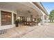 An outdoor patio features a dining table that overlooks the beautifully landscaped backyard at 4914 N Valley Gln, Litchfield Park, AZ 85340