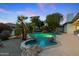 A sparkling in-ground pool with hot tub and waterfall feature enhances this home's outdoor living space at 4914 N Valley Gln, Litchfield Park, AZ 85340