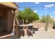 Relaxing outdoor bar area with a charming stone bar, seating, and beautiful desert landscaping for entertaining at 509 E Seco Pl, Phoenix, AZ 85086