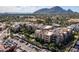 Aerial view of the complex featuring multiple units, a pool and mountain views in the background at 6166 N Scottsdale Rd # A3001, Paradise Valley, AZ 85253