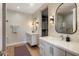 A spacious bathroom with dual vanities, framed mirrors, and neutral colored walls at 6166 N Scottsdale Rd # A3001, Paradise Valley, AZ 85253