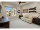 A neutral bedroom with a sofa, a window with a view, and carpeted floors at 6166 N Scottsdale Rd # A3001, Paradise Valley, AZ 85253