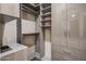Custom designed walk in closet with built-in shelving and drawers for ample storage at 6166 N Scottsdale Rd # A3001, Paradise Valley, AZ 85253