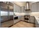 Gourmet kitchen featuring stainless steel appliances, light gray cabinets and quartz countertops at 6166 N Scottsdale Rd # A3001, Paradise Valley, AZ 85253