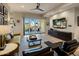 Comfortable living room with balcony access, hardwood floors, and stylish decor at 6166 N Scottsdale Rd # A3001, Paradise Valley, AZ 85253