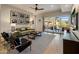 Bright living room with access to a balcony, hardwood floors and contemporary decor at 6166 N Scottsdale Rd # A3001, Paradise Valley, AZ 85253