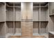 A spacious walk-in closet with custom cabinets and drawers, providing ample storage space at 6166 N Scottsdale Rd # A3001, Paradise Valley, AZ 85253