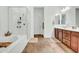 Bright bathroom featuring a soaking tub with glass shower and double sink vanity at 727 E Monte Way, Phoenix, AZ 85042