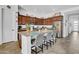 A well-appointed kitchen features dark wood cabinets, stainless steel appliances, and a granite island at 727 E Monte Way, Phoenix, AZ 85042
