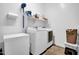 Well-equipped laundry room with washer, dryer, storage shelves, and large freezer at 727 E Monte Way, Phoenix, AZ 85042