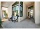 A covered patio features seating and a modern design with beautiful natural light and mountain views at 727 E Monte Way, Phoenix, AZ 85042